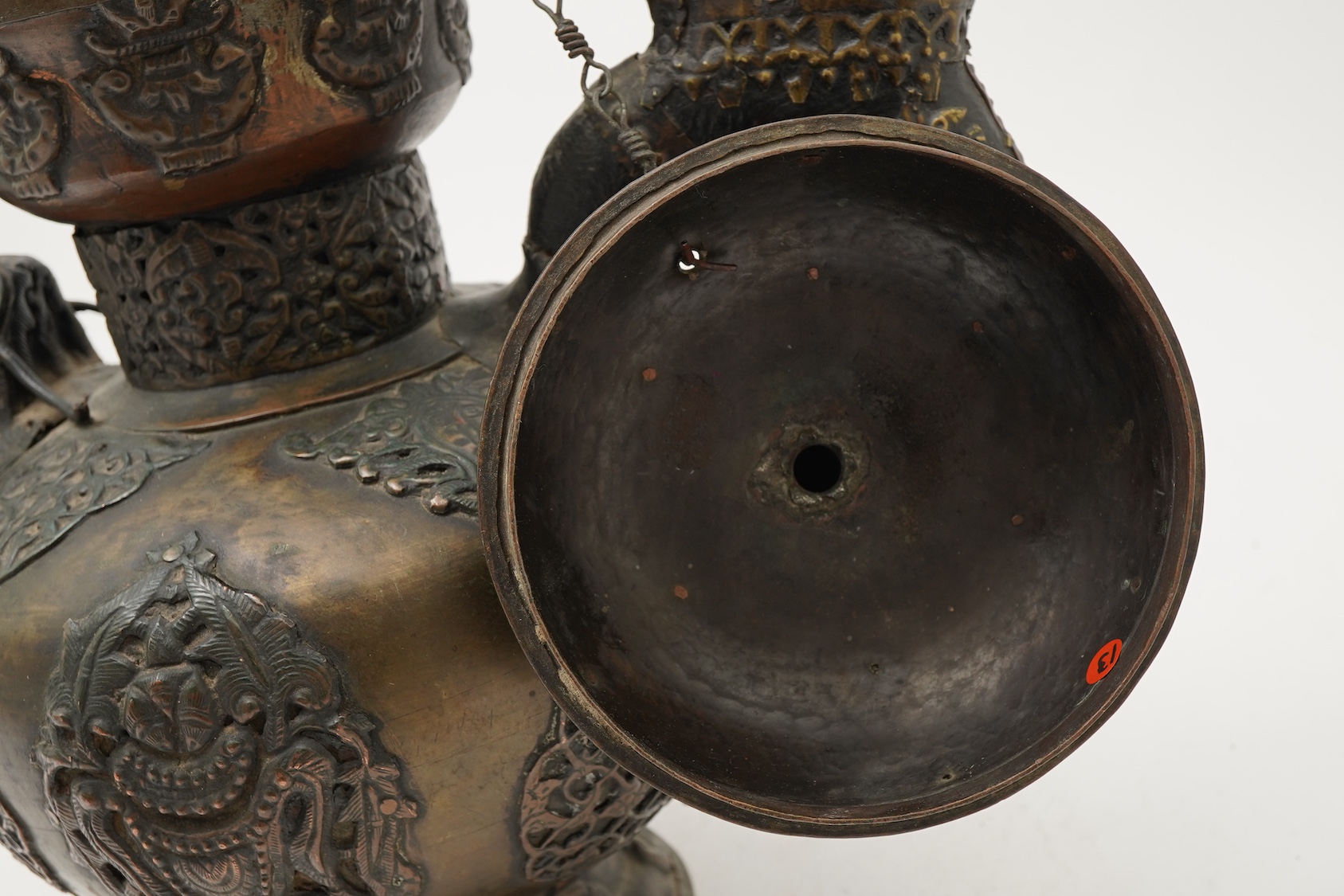 A large Tibetan repoussé brass and copper ewer, 19th century